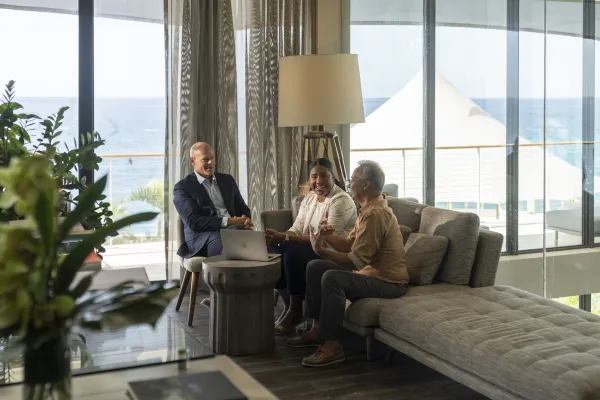 A corporate group of three people gather at the Loren hotel