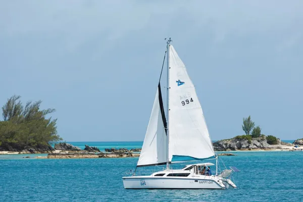 A sailboat from SeaSplash Bermuda Ltd. sails across a bay