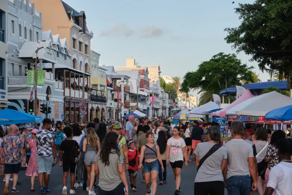 Patrons walk down a busy street lined with stalls in Hamilton, Bermuda for Harbour Nights