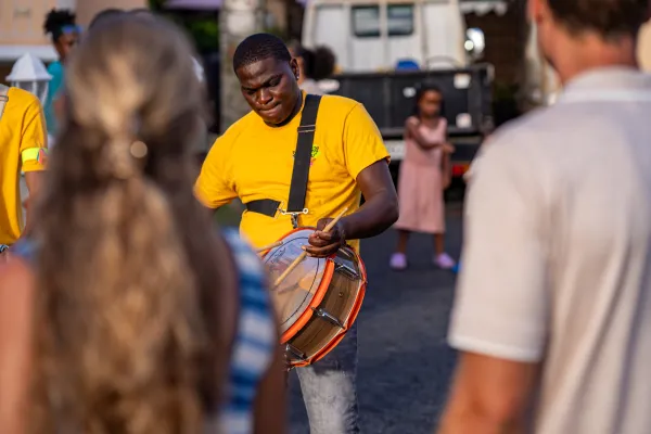 Drummers perform on the streets of Bermuda as a crowd watches