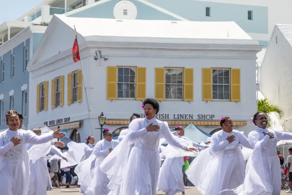 Dancers in white gowns participate in the Bermuda Day parade