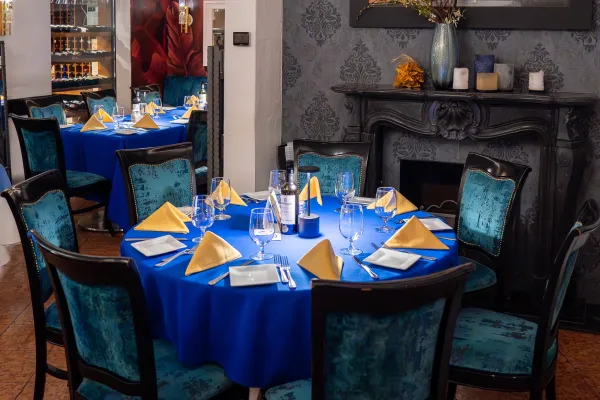 A table with a bright blue cloth at Little Venice in Bermuda