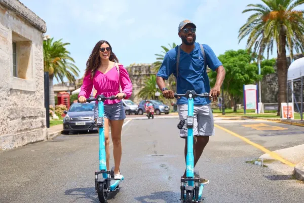 A couple riding electric scooters in Bermuda