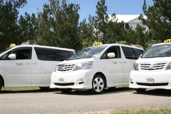 White rideshares vans in Bermuda