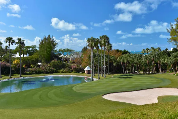 A hole with a water feature and sand trap at a Bermuda golf course