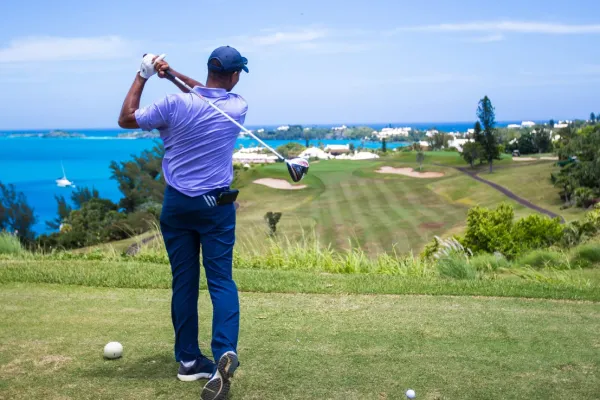 A man teeing off at the 17th hole at Tucker's Point Golf Club in Bermuda