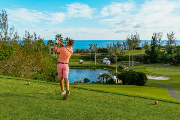 A man tees off at a Bermuda golf course