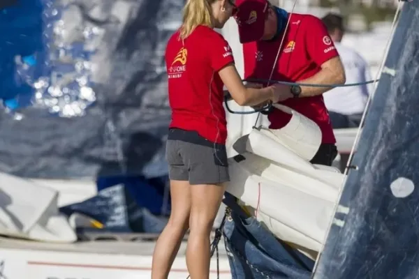 Two members of a sailing team prepare their ship for a race