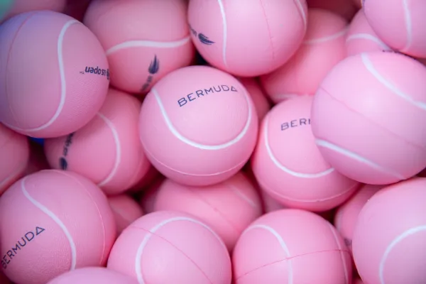 A collection of pink Bermuda-branded tennis balls