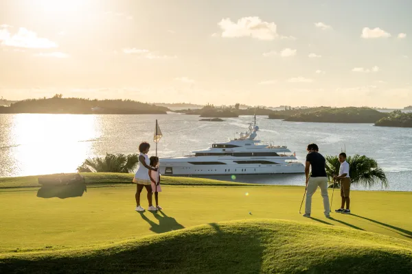 A Super Yacht moored off the course of Bermuda next to a golf course