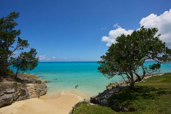 A family wading in the water at a cove beach in Bermuda