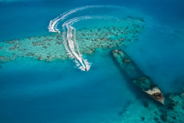 a person jet skiing near a sunken sea vessel off the coast of Bermuda
