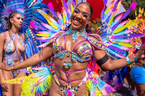 A smiling woman in a feathery carnival costume in Bermuda
