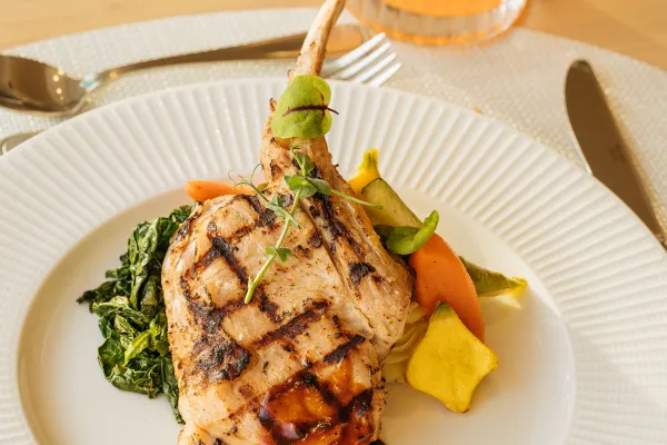 A grilled veal chop accompanied by a citrus cocktail at a Bermuda restaurant