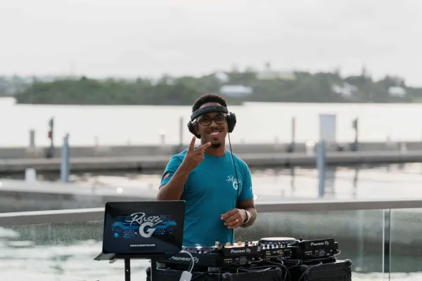 A DJ performs outdoors at the Bermuda Tourism Summit