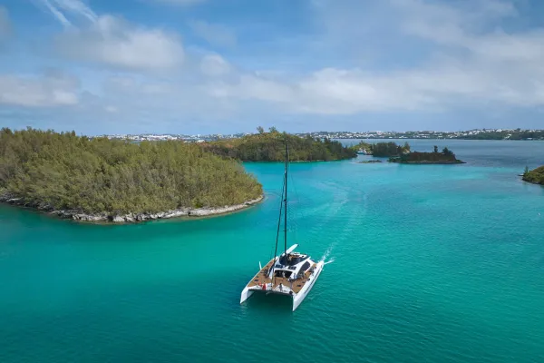 An aerial view of the great sound with a large catamaran in the middle.