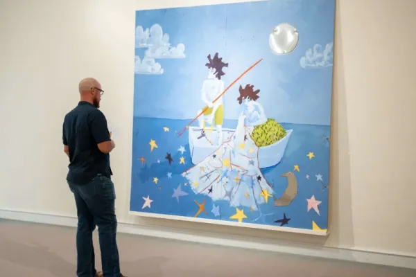 A man is standing in front of Art 