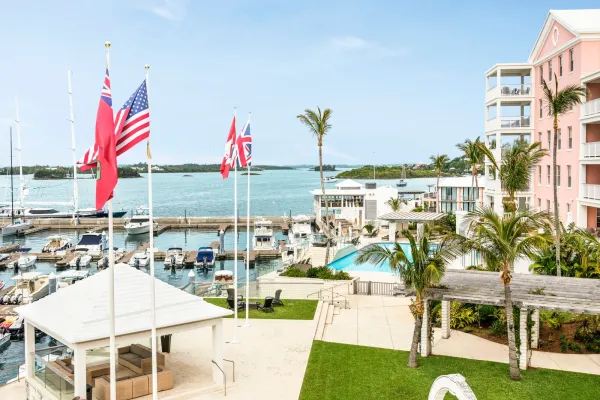 A couple holding hands in a terrace by the harbor at the Hamilton Princess Beach Club in Bermuda