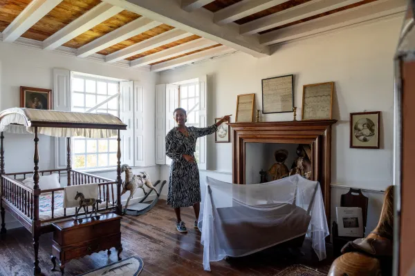 A woman at the Bermuda National Trust Museum pointing out artefacts