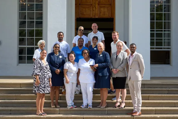 A group of Bermuda Hospitality Award Winners gathered on set of stairs