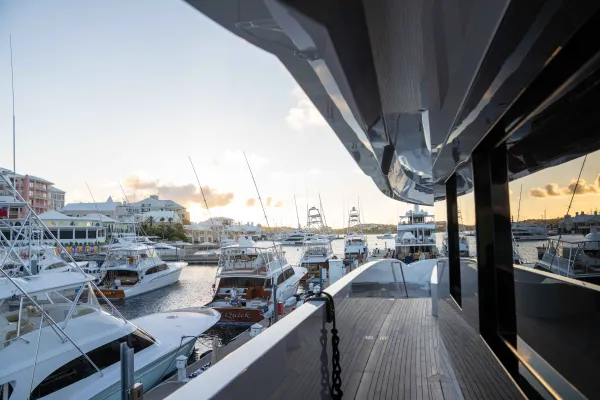 Eye level view of a Super Yacht by fishing boats.