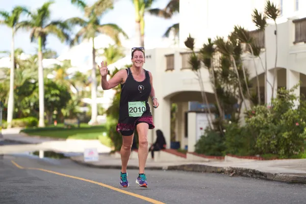 A woman is running on the road during a race