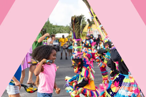 A little girl dancing with Gombey dancers in Bermuda