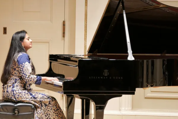 Charu Suri, famous pianist, is playing the piano. 