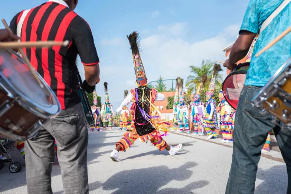A Gomeby Group is performing in the street with a dancer in the middle.