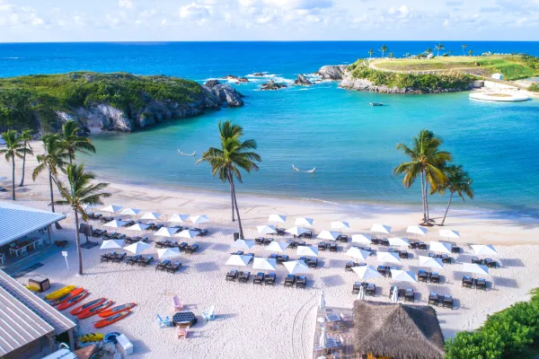 A row of umbrellas and loungers along Hamilton Princess beach in Bermuda