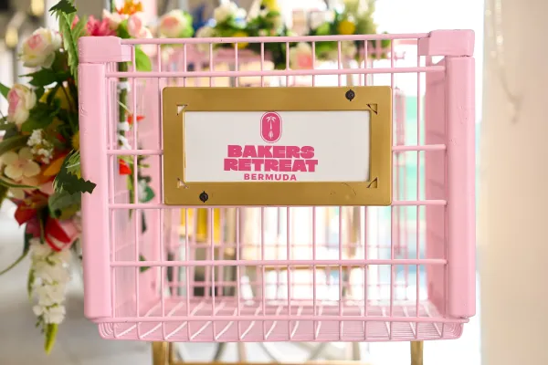 A pink basket with a sign that reads "Baker's Retreat"