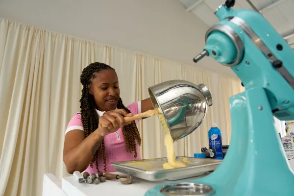 A woman spoons batter from a stand mixer onto a tray at the Baker's retreat in Bermuda