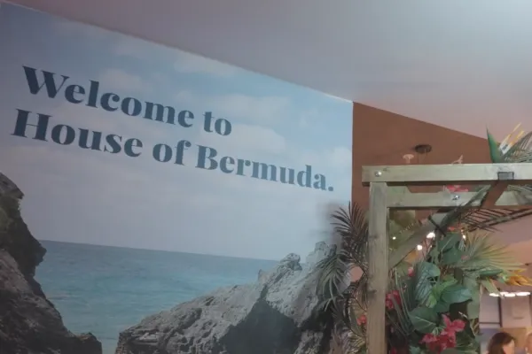 A banner that reads "Welcome to House of Bermuda" overlaid on an image of a Bermuda cliff