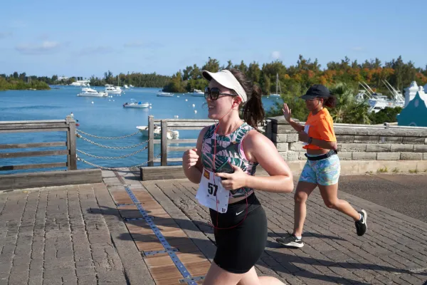 A marathon runner crosses a wooden bridge at a Bay in Bermuda