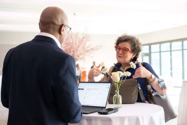 Two people conversing during business meetings