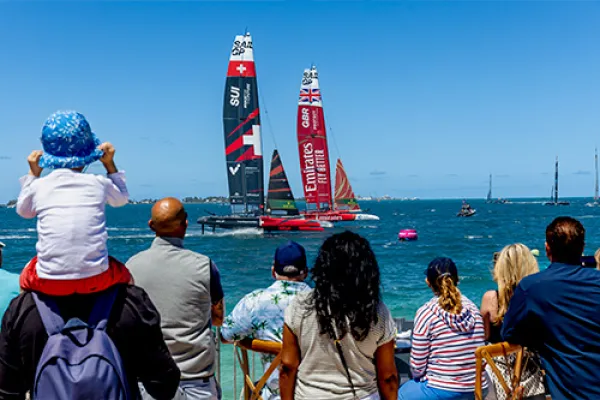 A group of people watching Sail GP Boats.