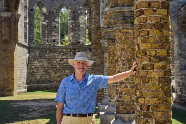 Peter Frith is standing in the unfinshed church.
