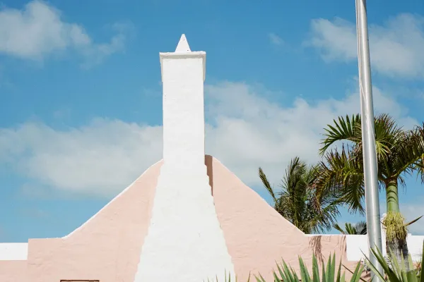 A wide angle view of a pink Bermuda styled building.