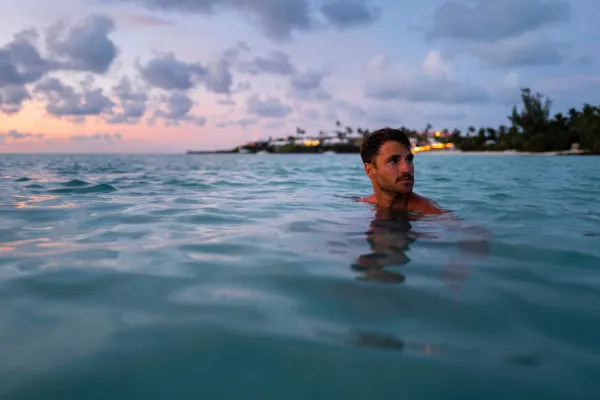A man is swimming at the beach.