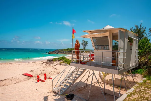 A life guard is standing at John Smith Bay