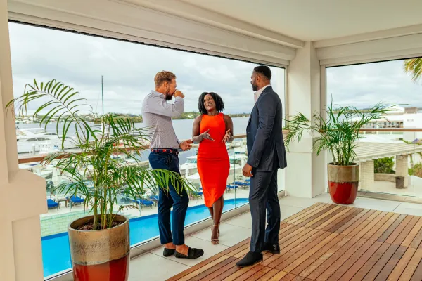 A group of business people are standing on a scenic deck.