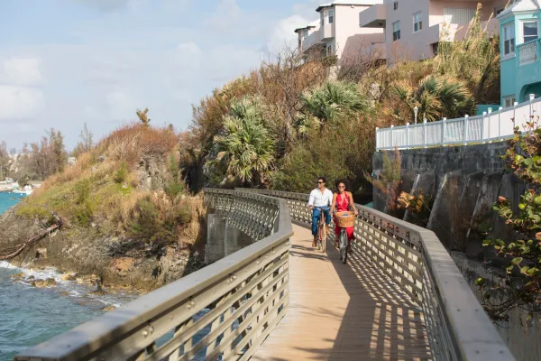 couple biking along a coastal section of the railway trail