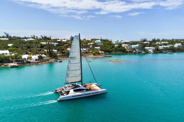 private sail boat gliding along the coastline