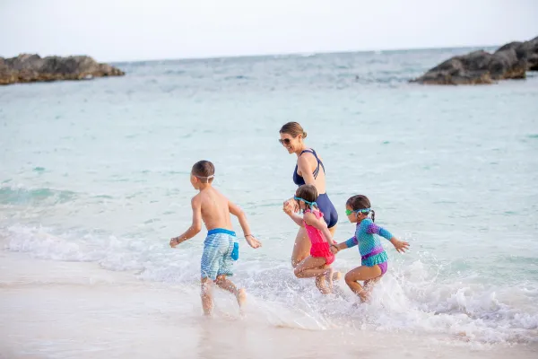A family running on the beach in Bermuda
