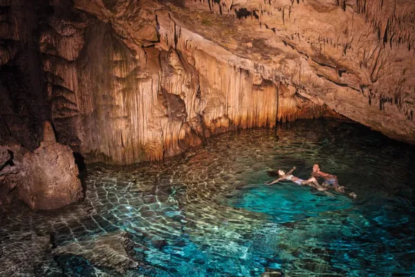 couple swimming in underwater cave