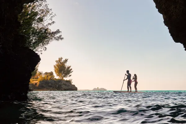 A couple is paddle boarding at Admiralty House