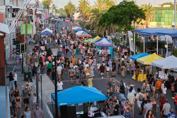 Front Street is filled with a large crowd and vendors.