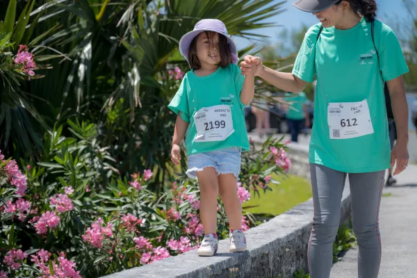 A little girl and her mom are walking during the Bermuda End to End.