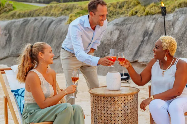 A group are cheerings at the Hamilton Princess Beach Club.