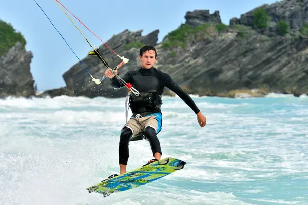 Kite surfer catching a wave